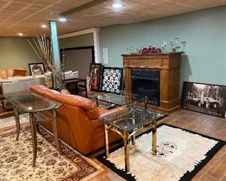 Burt orange paprika color leather sofa. Extra large natural gas fireplace with wood surround