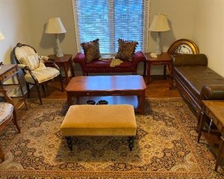 Lots of beautiful furniture! On the right side you will see a solid wood with tufted leather and rolled arms bench made by Lexington home furniture. On the left you’ll find a chair by Althrop. Lots of beautiful area rugs throughout the home for sale. 