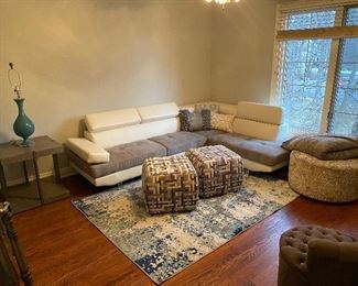 Modern contemporary leather and upholstered gray and white sectional. Gray and white Ottomans. Modern gray end table. 