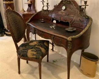 Fine ladies desk w/bronze mounts fitted with clock in center top and bronze lighted candle holders to each side.  $1,000
