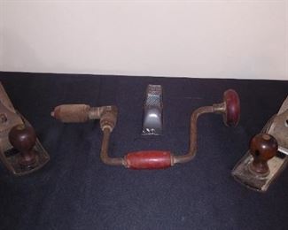 Sun Room:   Two separately priced antique planes flank a newer, small plane and an antique brace (hand drill).  The plane on the left is a STANLEY Bed Rock 604; the other is a STANLEY Bailey  No. 5. 