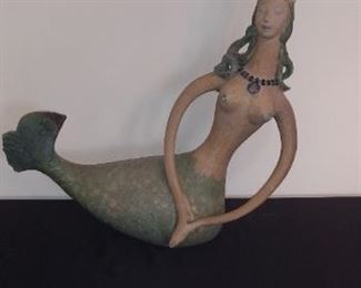 Sun Room:   What a fun clay piece!  This mermaid measures 22-1/2" from tail to arm and 21-1/2" from bottom to top of her crown.   A closer photo follows.