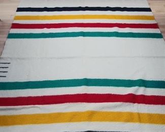 Sun Room:   This 1960's wool HUDSON BAY blanket (made in England) has the iconic design with the green, red, yellow and black stripes. It has four black points, as seen on the left in the photo, and measures 72" x 91".  The next photo shows the blanket label.