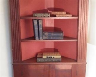 Living Room:  A corner display cabinet has four upper shelves and two lower doors.  It measures  73" tall x 34" wide.