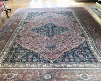 Living Room:  This antique "Persian Bidjar" rug has a diamond center and rich colors of red and blue.  It measures approximately 11'  x 7'   7".  Photos of the doll furniture and rocking horses in the background follow.