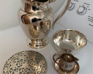 Item #202   $45/ lot     Silver plate water pitcher, Revere bowl, plate and glass trivet, small creamer and bowl