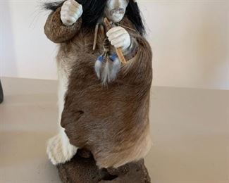 Item #139  $200   Carved fossilized walrus hand and face with hide, mounted and signed by Richard Miller (Alaska), 11 1/2"