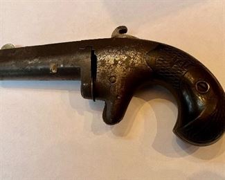 Item #109 Rare Number 2 Antique Colt Derringer This is serial # 3129 of approximately 9000 pistols made between 1870 - 1890 This derringer is a single shot side breach style loader pocket derringer with a 2.5” barrel. It was popular with gamblers and business men. With its .41 caliber shot it was capable of stopping your opponent quickly. Knurled release latch on frame R.H.side, barrel pivots left for loading. Steel frame with foliate engraving on either side, steel barrel with bladed front sight, knurling on hammer is course style and split by a central groove to act as a rear sight, sheath trigger, wooden birdshead grips. Stamped on barrel with two-line Colt address. Price $1000