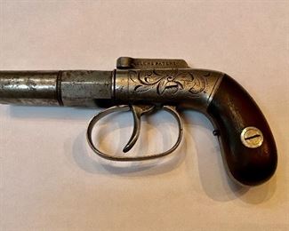 Item #110 Antique Allen and Thurber D. A. Bar Hammer Pistol This Allen and Thurber single shot derringer was manufactured from 1830 - 1835. It is an early production with serial #253. Several variations of these pistol exist, this has the sharp angle grip style. 2 inch barrel, .31 caliber smooth bore, single shot percussion cap fired. Metal is brite with scroll work on the frame and fine knurled barrel ribs with octagon barrel base, with hard wood grips. The hammer action works when the trigger is pulled. Makes a fine display of a gun over 180+ years old. Price $1550