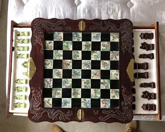 Vintage Asian chess board with green and red chess pieces.