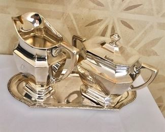 $550 Sterling sugar and creamer monogramed .  Sugar bowl: 5.25" H; creamer: 5.75" H.  Coin  (800) silver tray: 10.5" L, 4.75" W. 719 g all