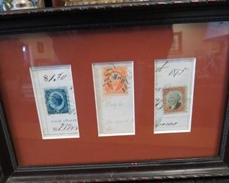 Framed antique stamps.