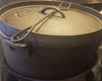 Several vintage cast iron pots and pans