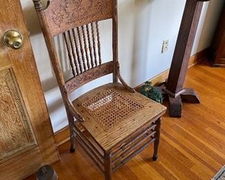 Antique press-back chair with cane seat