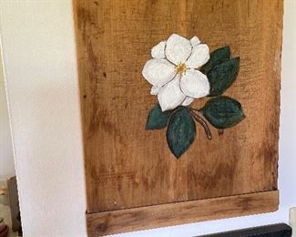 Old breadboard with painting of magnolia