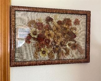 Dried flower arrangement in decorative frame