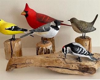 Item 320:  Peter Peltz Vintage Carved Birds:                                                a) Yellow Finch (far left): $95 (SOLD)                                                       b) Red Cardinal (center): $125                                                         c) Black and White Bird, center in front of Cardinal: $95 d) Woodpecker (foreground): $115   (SOLD)                                          e) Brown Songbird (right rear): $95                                                       Tallest - 5.75"