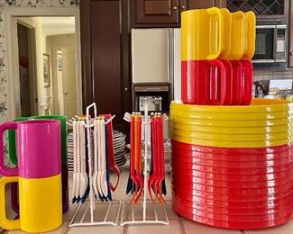 Item 354:  Left - Heller Max Mugs (4): $34                                                     Item 355:  Center - Vintage Hanging Plastic Cutlery: 
$18/each set                                                                                          Item 356:  Right (top) - Beacon Volare Mugs: $12                                     Item 357:  Right (bottom) Vintage Oblique by PMC Plates: $32 for Yellow set of 6 and $28 each for set of 6 Red Plates