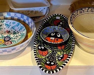 Assorted serving platters, bowls, and appetizer sets all priced at the sale.