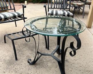 Outdoor wrought iron chairs with foot rests and wrought iron circular table	Table 22” x 24” in diameter chairs 36” x 25” seating height 19 inches	

