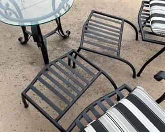 Outdoor wrought iron chairs with foot rests and wrought iron circular table	Table 22” x 24” in diameter chairs 36” x 25” seating height 19 inches	
