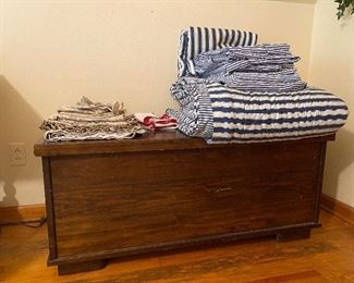 Cedar chest. Blue and white King bedding