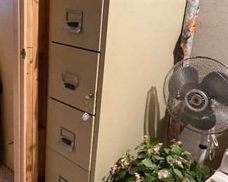 4 drawer filing cabinet with key, oscillating floor fan, artificial flower arrangement, roll of fabric