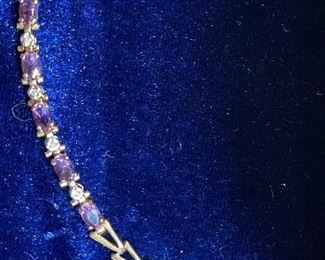 17_____ $100 
10kt yellow gold link bracelet with amethyst stones 0.14oz - 7  1/2 inches