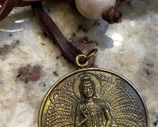 25_____ $50 
leather & pearls necklace with buddha medal