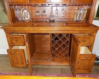Tommy Bahama Sunset Hutch.  This beautiful wine hutch and buffet matches the dining table.  It is part of the Tommy Bahama Collection by Lexington Furniture and it features wine bottle storage, wine glass storage, plate racks, 8 drawers, large storage cabinet and an upper display cabinet.  It comes in two pieces.  Excellent condition.  It is 91" tall and 66" wide.  $1000.