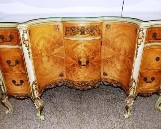 Antique French Rococo Louis XV Style Burlwood Writing Desk.  This gorgeous, ornate desk was made c. 1910 and has been passed down in the family through many generations.  It is truly a piece of art.  It features a glass top, 7 pull out drawers and a storage cabinet.  It is in excellent condition accept for one of the drawer handles will need to be repaired.  The seller has the original handle but it will need a new fastener and to be secured to the desk.   The desk is 52" long x 30" tall x 20" deep.  $5000.