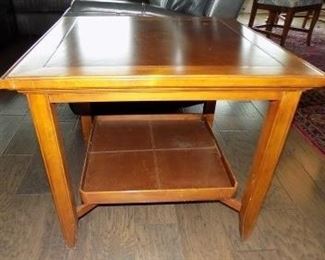 End Table with Serving Tray - This 28" square end table features a serving tray that is stored on the bottom rack and can be pulled out and used when the need arises.  It does show signs of wear and tear with numerous scratches and small dings on the wood.  It stands 24" tall.  $45