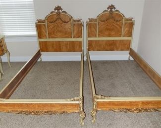 2 French Rococo Louis XV Burlwood Twin Bed Frames - This gorgeous pair of French Rococo Louis XV style twin beds must be bought as a set.  These were made in the USA, Circa 1910 of exotic burled African avodire wood, with paint and gilt details.  Both frames are in very good original vintage condition however, both finials have been broken and glued back on.  Headboard Measures: 51"H x 42" L.
Footboard height: 45"L x 17"H.    $2000  for set.