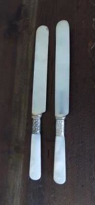 2 1930's American Cutlery Company P1865 Breakfast Knives - The silver bands are not marked sterling so it is unclear if they are indeed sterling or not. The pearl handles are in good condition and are about 2.5" long.  The bolsters are showing signs of rust and corrosion.  The blades are in used condition.  $15