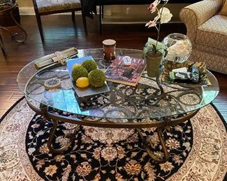 Glass & iron Coffee table on top of round carpet