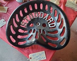 One of the first tractor seats ever made. Circa 1900 Stoddard tractor seat made out of heavy thick cast iron.  Tractors were invented about 1892.  Stoddard family made a fortune selling these and other farm items then went into auto racing. 
