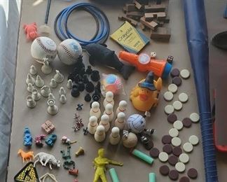 all on table old toys bakelite? checkers basket of old legos, game pieces baseballs etc