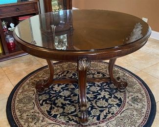 Beautiful foyer table with ornate feet, gold accent trim and glass top, by Kistler. 47"d x 31"h