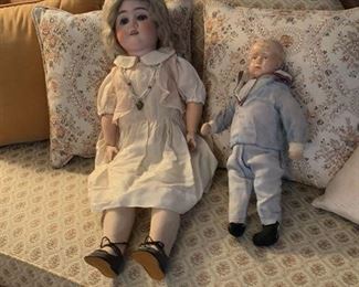 25"German Doll with bisque head. open mouth showing teeth. Wooden jointed body, arms , hands, legs.  in original clothing and shoes