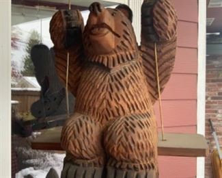 Carved wooden bear on a swing