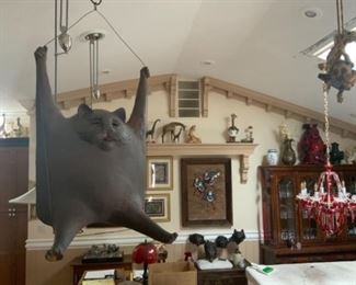 Al Davis pottery cat on a swing