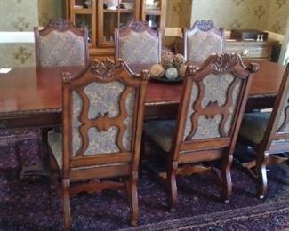 Very ornate and Beautiful dining set purchased at Nebraska Furniture Mart 6 chairs and 2 Captain's chairs. Has 2 leaf extensions in making this table 8 ft 10" L x 44"  *each leaf is 18" x 44"