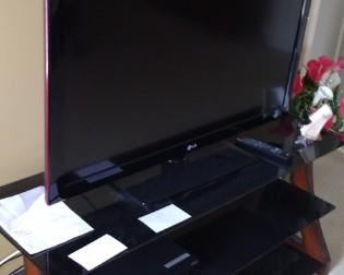 40" LG TV and 50" wide x 18" deep x 23 5/8" high TV stand