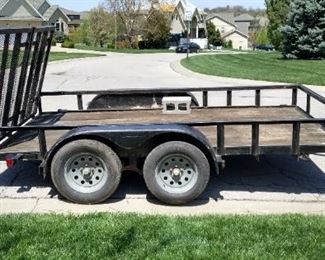 The 16-foot utility trailer has a 10-inch hole in the ramp and the wheel is broken on the  trailer jack and the tailgate is slightly bent.