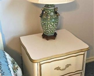 One of two white French Provincial nightstands
