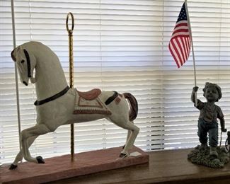 Carousel horse; small boy proudly waving his flag