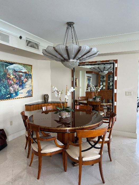 Gorgeous round table with a leaf and 6 arm chairs by Designed by Enrique Garcel handmade in Columbia for "Today's Custom Design" marked $2500.  I believe the mirror is also from them marked $2500.  The Art Deco Style Chandelier is unsigned and is approximately 4 feet in Diameter by about 16" in depth of glass marked $3,500. 