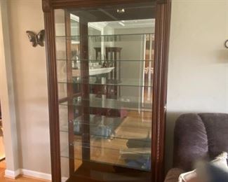 Large mirrored and lighted glass display case with sliding door