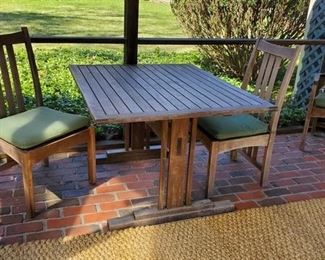 Teak table. Four chairs. Two additional leaves
