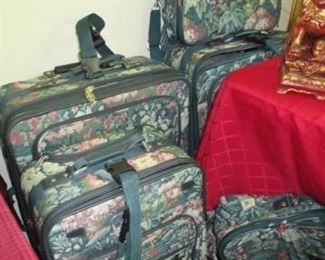 Luggage.  2 large suitcases, 1 medium suitcase 3 smaller bags